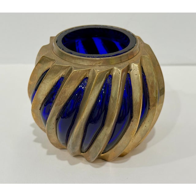 Unique, brutalist solid brass tea light holder with caged cobalt glass interior. Acquired from the vintage market in...