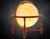 Mid 20th century lighted globe lamp featuring a traditional world globe mounted within a turned wood stand. The classic...