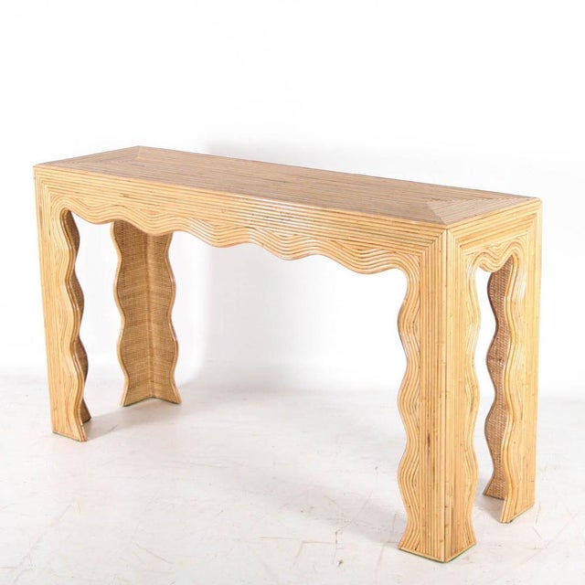 Incredible rattan console table in the shape of waves. The inside of the legs is made of raffia. This sculptural console...