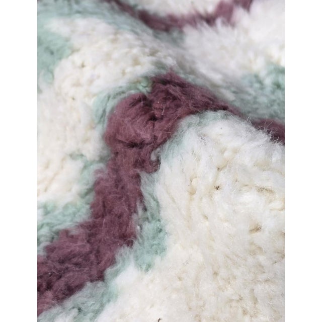 Ivory, Sage & Plum Moroccan Rug – Handmade Berber Wool Carpet This elegant handmade Moroccan rug features a soft ivory...