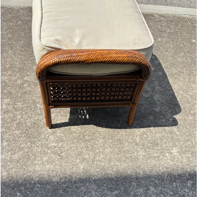 Rattan and Wicker Footstool in a great style and accompanied by a linen color cushion .