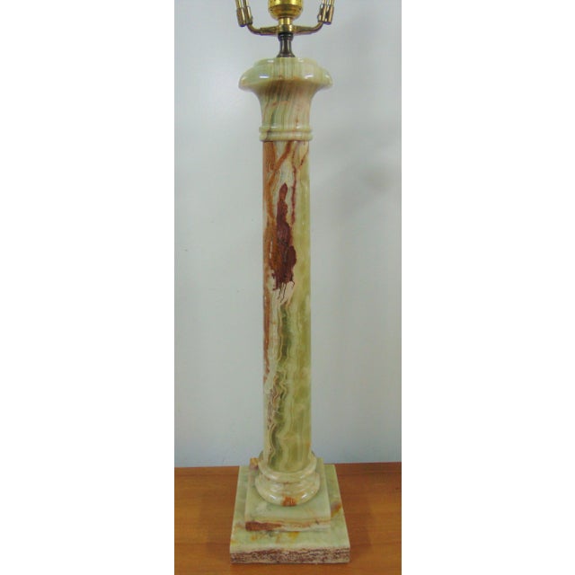 A pair of Mid Century Modern Lamps. Made in Italy, column form, made of oynx. Brass harp has 7" of adjustment for use with...