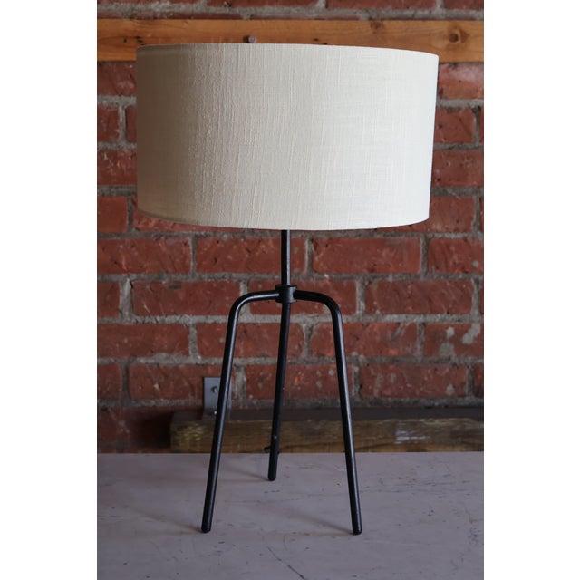 A vintage table lamp, 1950s. Newly rewired with a custom linen shade. The base shows patina. The base is 9.5" W x 8.5" D....