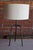 A vintage table lamp, 1950s. Newly rewired with a custom linen shade. The base shows patina. The base is 9.5" W x 8.5" D....