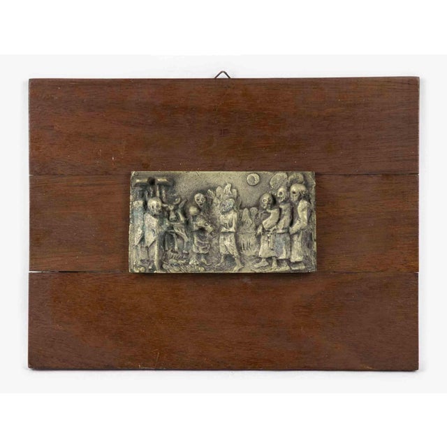 Wood base with brass relief is an original decorative object realized in the early 20th century. Made in Italy. The base...