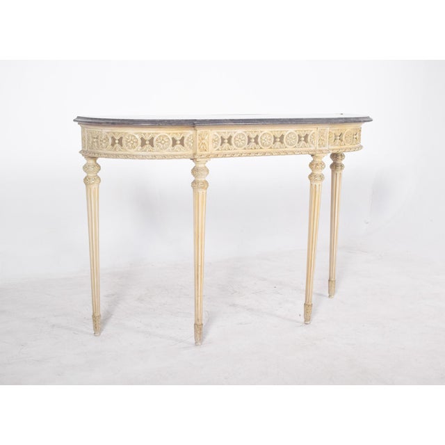 Credenza with marble top. with its delicate decoration, it evokes the refinement of French neoclassical furniture. The...