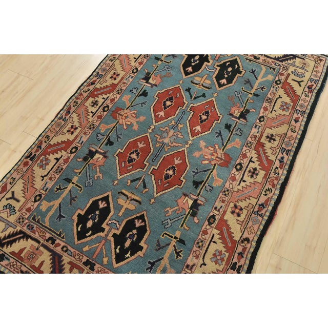 An authentic vintage tribal Heriz rug hand-knotted with fine wool on a cotton foundation. This rug features geometric...