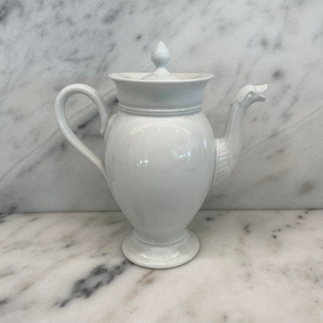 Elegant antique French white porcelain teapot or coffee pot, featuring a baluster-form body, flared collar, domed lid with...