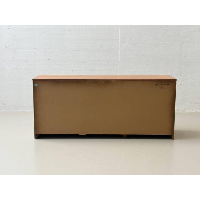 A characterful 1970s sideboard with a warm, natural feel and elegant combination of materials. The body is finished in a...