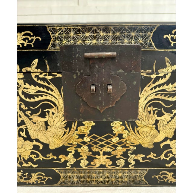 Here is an incredible Asian Chinoiserie black lacquered chest that is highly decorated with gorgeous scenes in gold. As...
