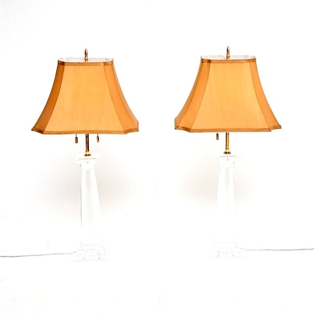 An extremely stylish and highly sought after pair of vintage acrylic and brass table lamps by Karl Springer. They were...