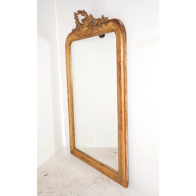 Antique French made Louis Philippe giltwood mirror. It features the rounded upper corners paired with a straight bottom...