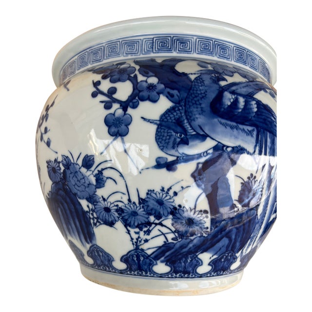 The is a vintage Japanese blue and white porcelain planter or jardinière. It features an intricate, hand-painted design of...