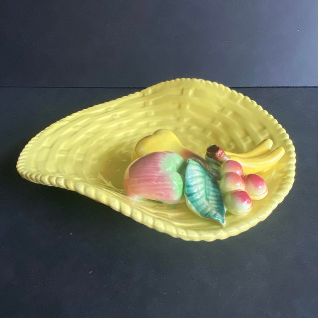 Vintage yellow basketweave trinket dish featuring relief fruit and rope design trim. Circa mid 20th c. Marked on bottom.
