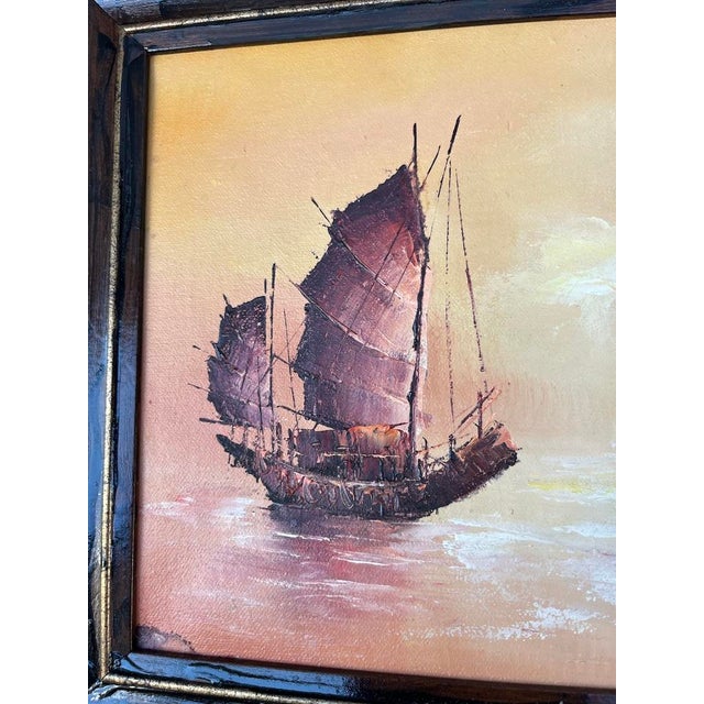 A single vintage rectangular oil on canvas painting featuring Chinese junk ships. Finished with a dark stained wood frame.