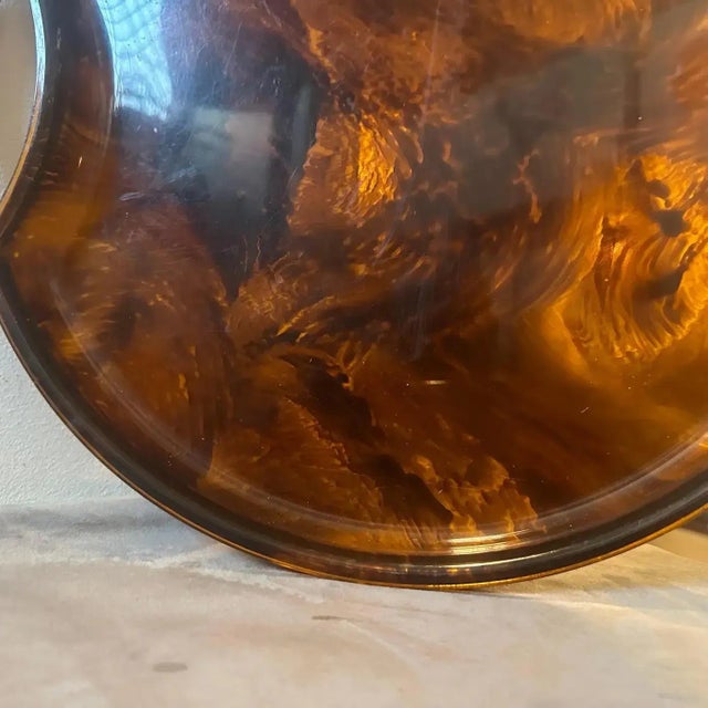 A Modernist Fake Tortoise Lucite and Brass round tray designed and manufactured by the Italian design company Guzzini...