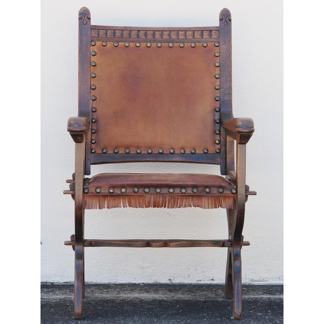 Skilled joinery is on full display in this gothic arts and crafts style chair, crafted in solid wood with a leather seat...