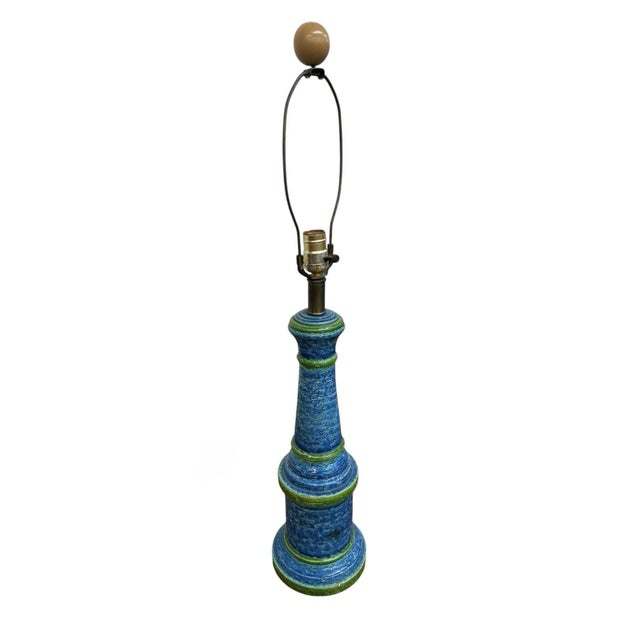 The product is a vintage Mid-Century Modern turquoise blue Bitossi table lamp made of Italian pottery. This original piece...