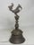 Antique Indonesian brass bell, c.1880 The top finial is a mythical bird, below which is a shaped carved handle. The...