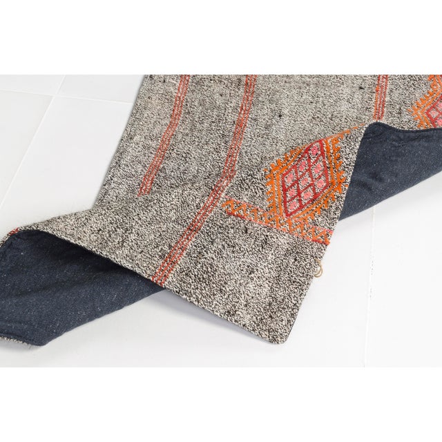 This is a vintage Turkish Oushak rug from the Mid 20th Century. The piece was hand-knotted.