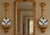 A striking pair of carved giltwood wall brackets with small projecting shelves. The elongated design features scrolling...