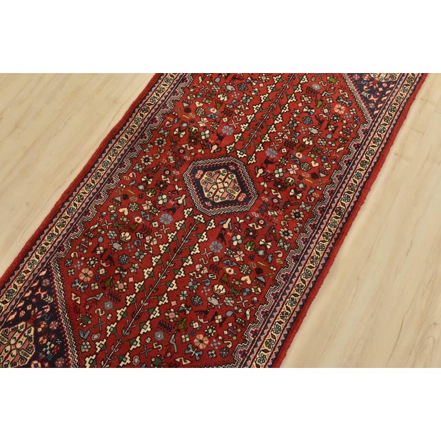 An authentic vintage tribal Abadeh runner hand-knotted with fine wool and natural dyes. This intricately woven rug...