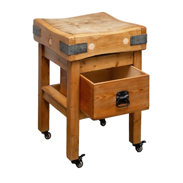 A handsome butcher's chopping block on stand or table of pine and beech wood from England, featuring a large, square...