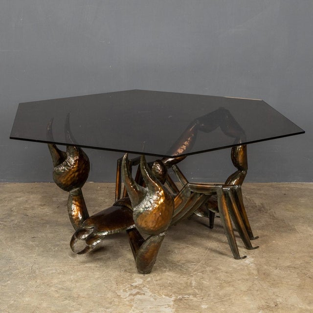 An unusual metal sculpture of a Scorpion supporting a large hexagon of smoked glass creating a striking coffee table. Of...