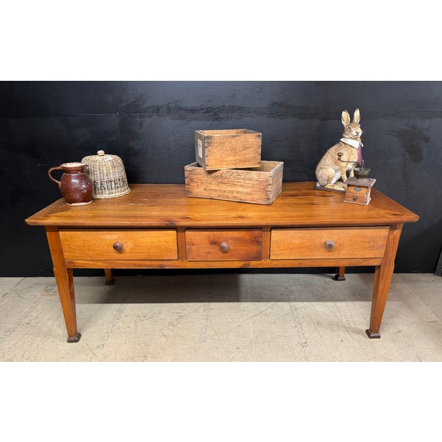 A warm and beautiful French 18th Century Console Table. Made from Cherry Wood, having 3 deep drawers to the front and 3...