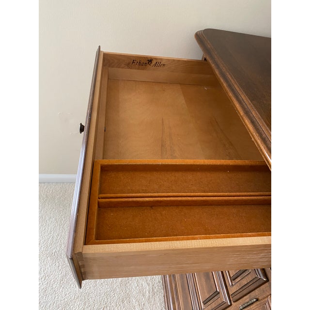 This beautifully maintained Ethan Allen dresser and mirror was cared for by one owner for over 50 years. The dresser base...