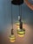 Vintage space age cascade pendant lamp by Massive. The lamp consists of 3 glass shades with chrome and green acrylic...
