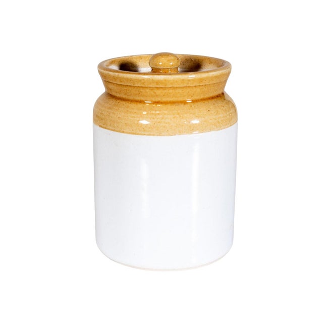 Small handmade ceramic jar with lid. White and mustard glaze finish.
