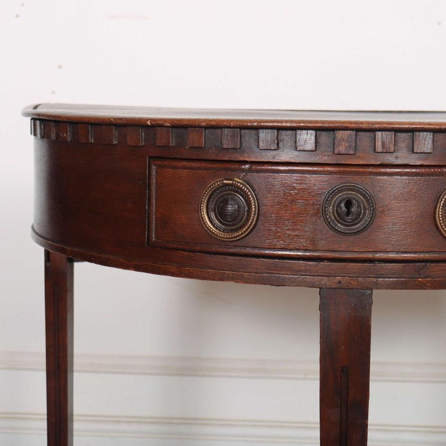 Early 19th Century Dutch oak demi lune console table. 1830 This piece is designed in the style of the selected designer...