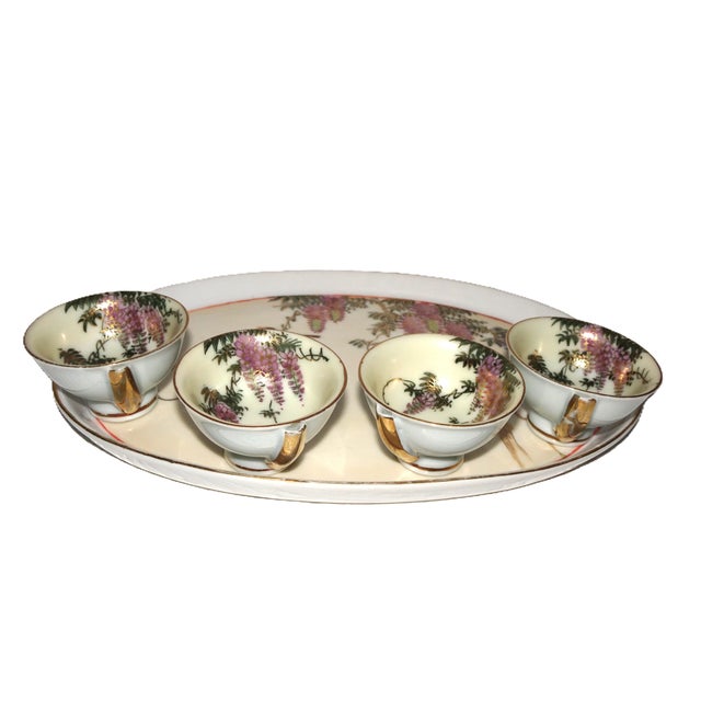These are Japanese sake cups and matching tray. Pieces are made of porcelain and hand painted in a Wisteria motif. Very...