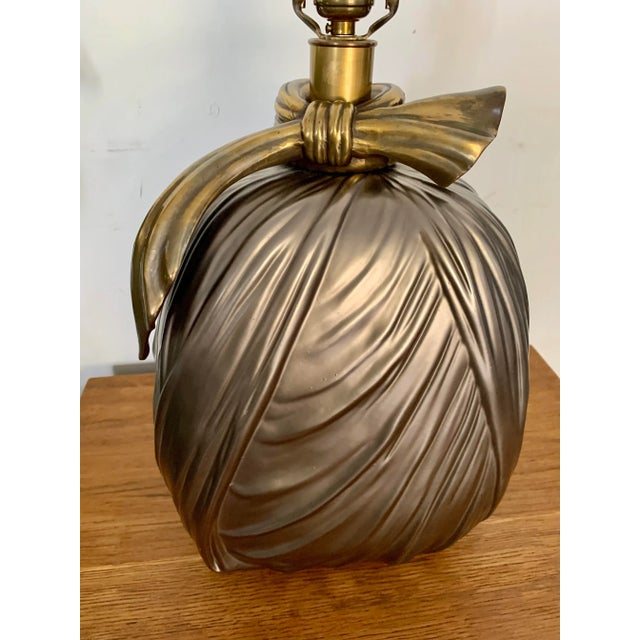 Chapman faux draped fabric ceramic table lamp with a bronze finish. Beautiful brass “tie” around the neck of the piece and...