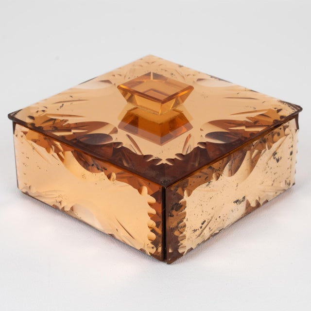 This stunning mirrored glass decorative box was crafted in the 1940s. The square design features pink peach-colored glass...