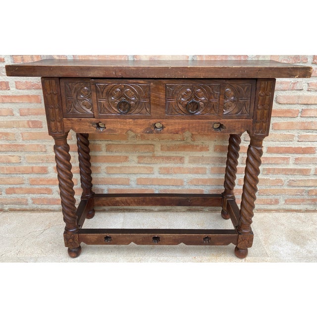 20th century console table with slab top on a frieze with two drawer fronts decorated with carved and incised floral...