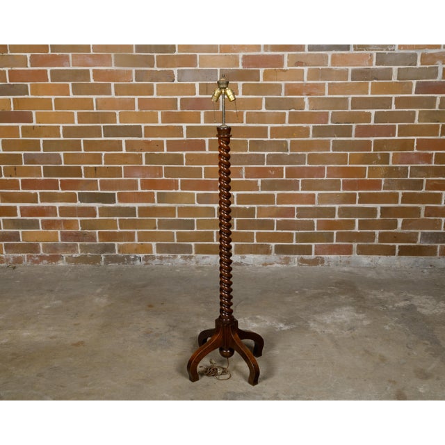 An English Turn of the Century walnut barley twist floor lamp from circa 1900 with two sockets and quadripod base. Born in...
