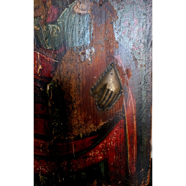 This is an antique wooden icon resembling the Byzantine Hodegetria type, which depicts the Virgin Mary pointing to Jesus...