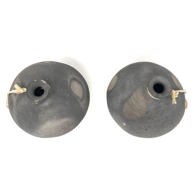 Pair of 1950s-1960s handmade black pottery jars from the Oaxaca Region in Mexico originally used to store and transport...