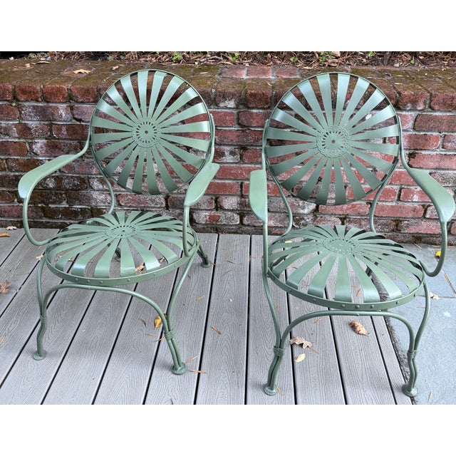 Set of two petite Sunburst chairs made in France in the 1930's by Francois Carre. They have been powder coated in an olive...
