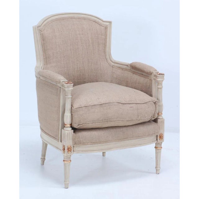 Painted and gilt Louis XVI style bergere chairs circa 1950 with recent burlap fabric.