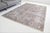 This is a vintage Turkish Oushak rug from the Mid 20th Century. The piece was hand-knotted.