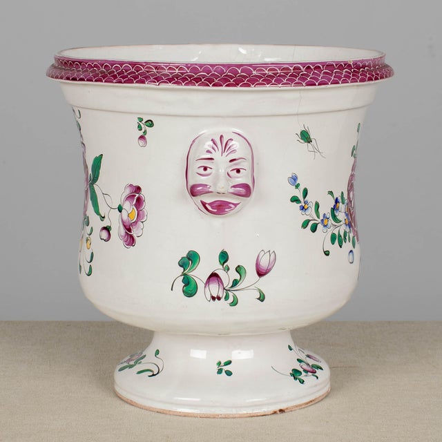 A French faience Lunéville Saint Clément cache pot, or planter. Hand-painted in typical floral design with vivid colors of...