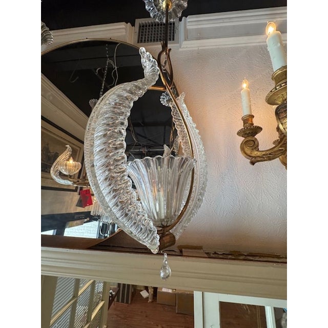 The Vintage Murano Glass and Brass Pendant is a stylish and unique piece of lighting that adds a touch of elegance to any...