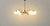 A striking Sputnik ceiling light from the 1950s, featuring a delicately curved brass frame and six opal white glass...