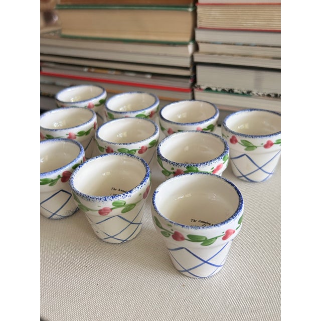 Set of 11 vintage ceramic napkin rings shaped like miniature flower pots, hand-painted with cobalt blue latticework and a...
