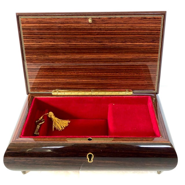 Beautiful Italian Reuge music box has a rich dark brown base and is enhanced with a floral display on top in a range of...
