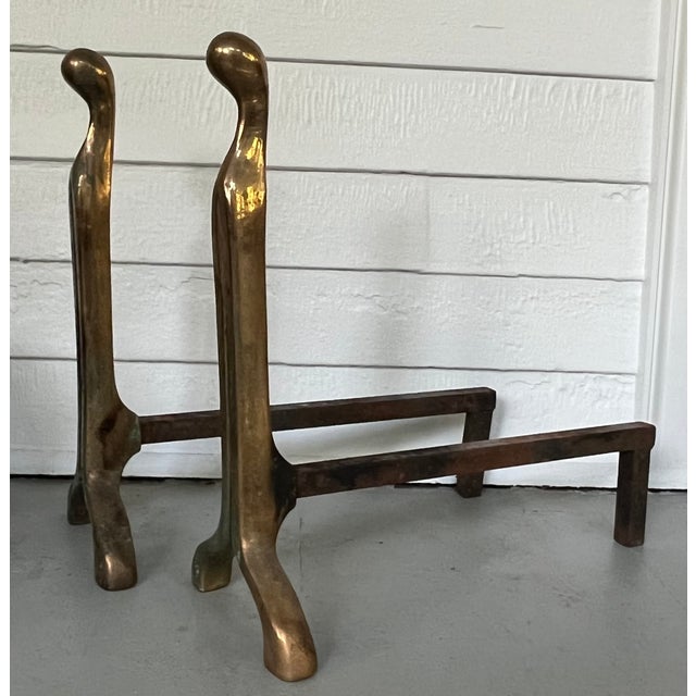 Pair Nancy Ruben Mid-Century Modern figural brass and iron andirons. Measure 18 3/4" tall x 8 1/4" wide x 18 1/4" front to...