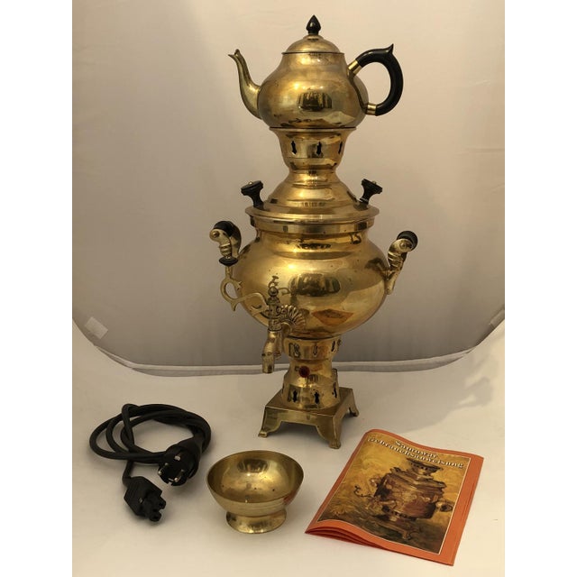 This magnificent samovar made of shiny brass is a true highlight of traditional tea culture and combines functionality...